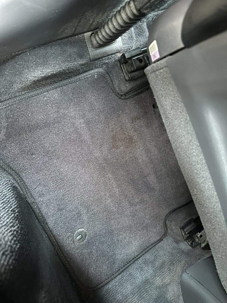 Before professional interior detailing - dirty stained car carpet in Hyundai Ioniq